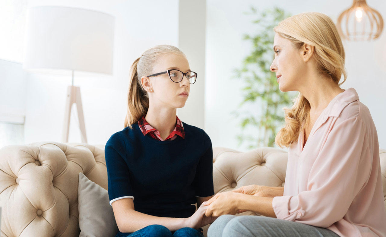 Photo of a mother talking to her daughter about mental health help