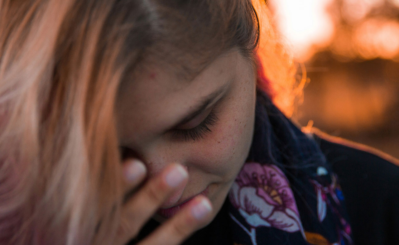 A photo of a teenage girl looking stressed.