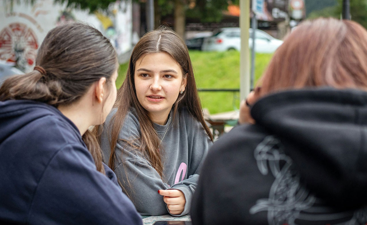 A photo of two teenage girls talking to each other.