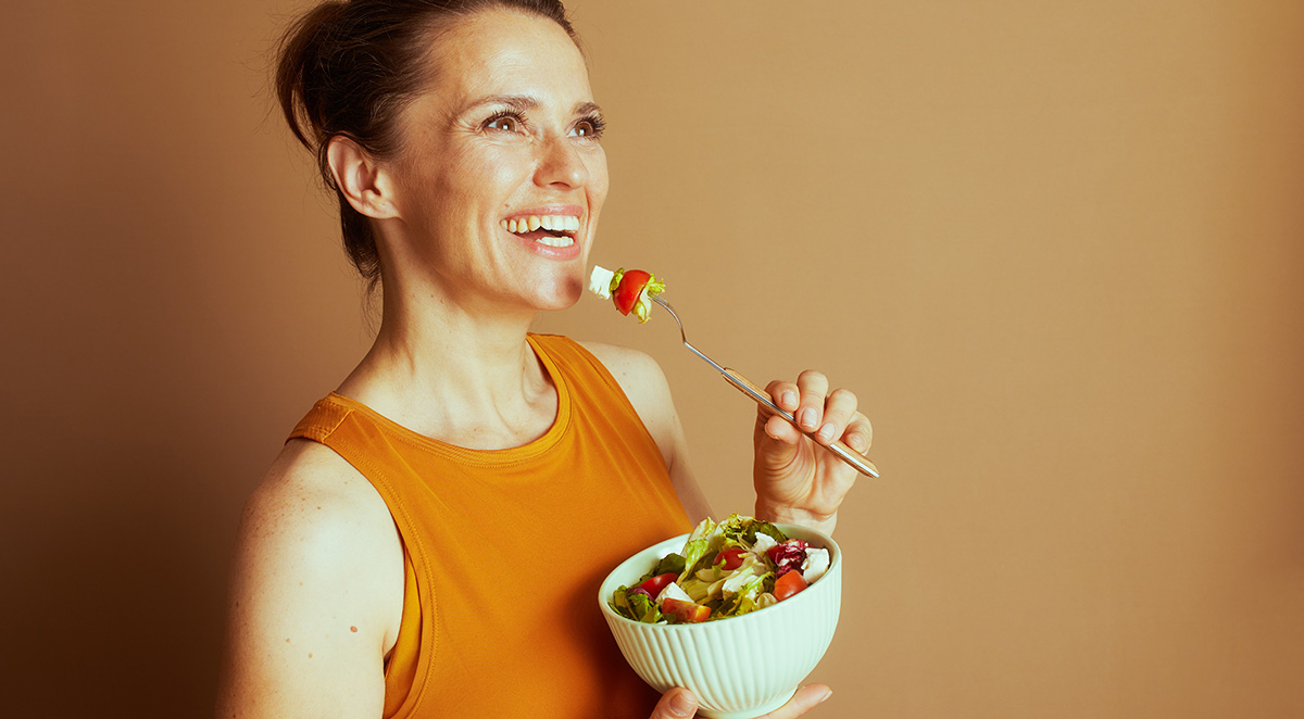 Woman eating from bowl of food