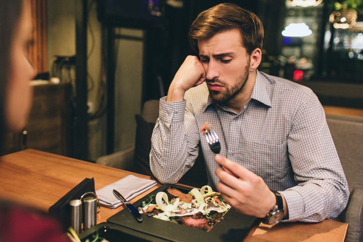 man-looking-unhappiily-at-his-food