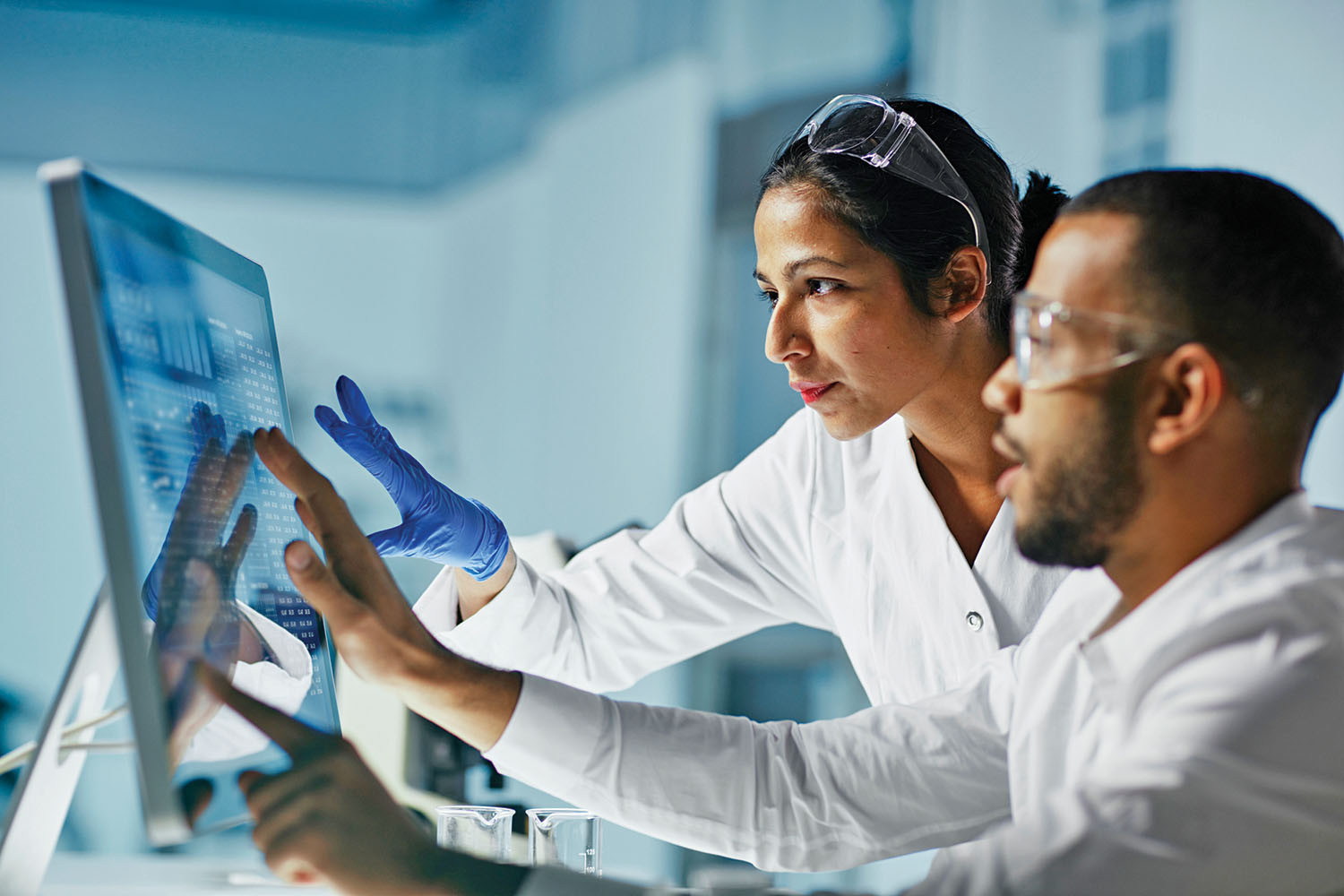 photo of two scientists viewing data on a computer screen