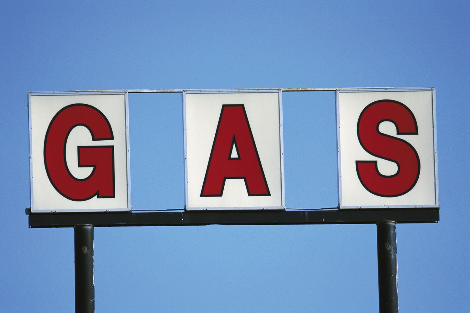 photo of an outdoor sign with individual lettered panels spelling out the word gas