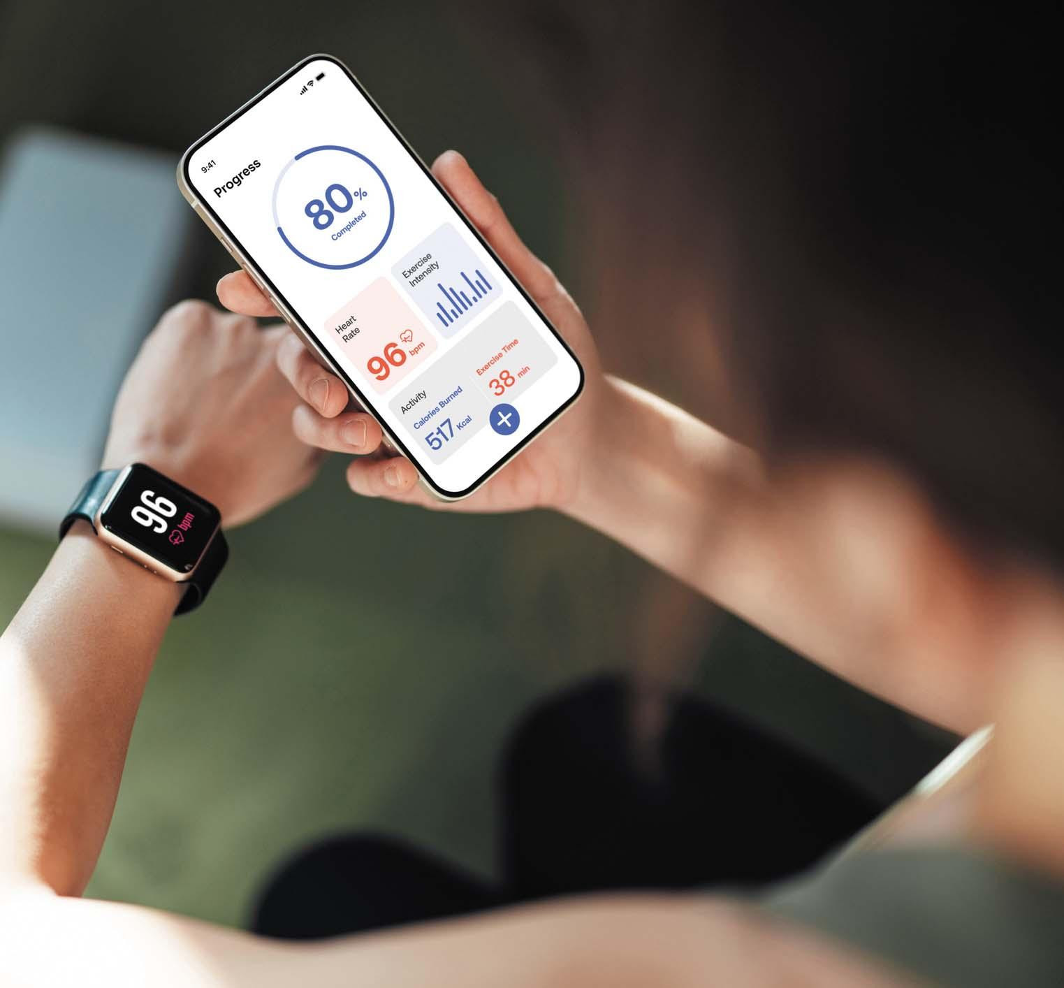 Close-up of a person's hands holding a smartphone showing a health tracking app.