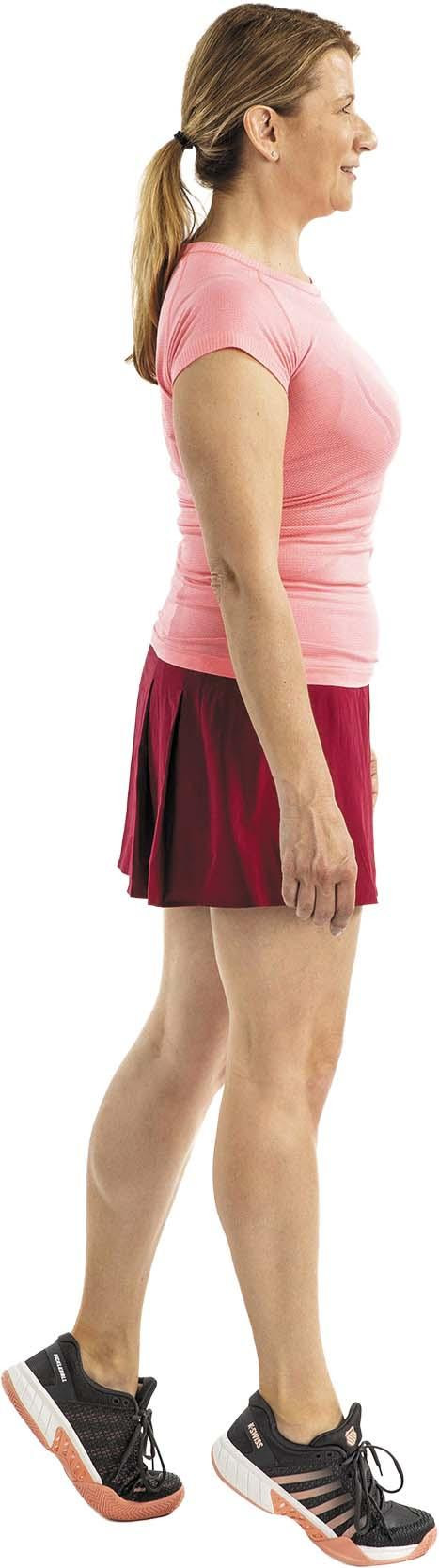 A woman performs the heel portion of the heel and toe walk exercise as described in the article.