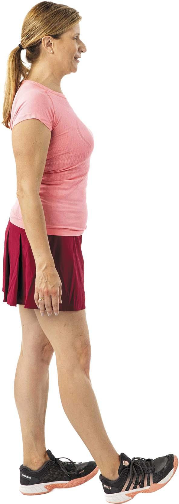 A woman performs the toe portion of the heel and toe walk exercise as described in the article.