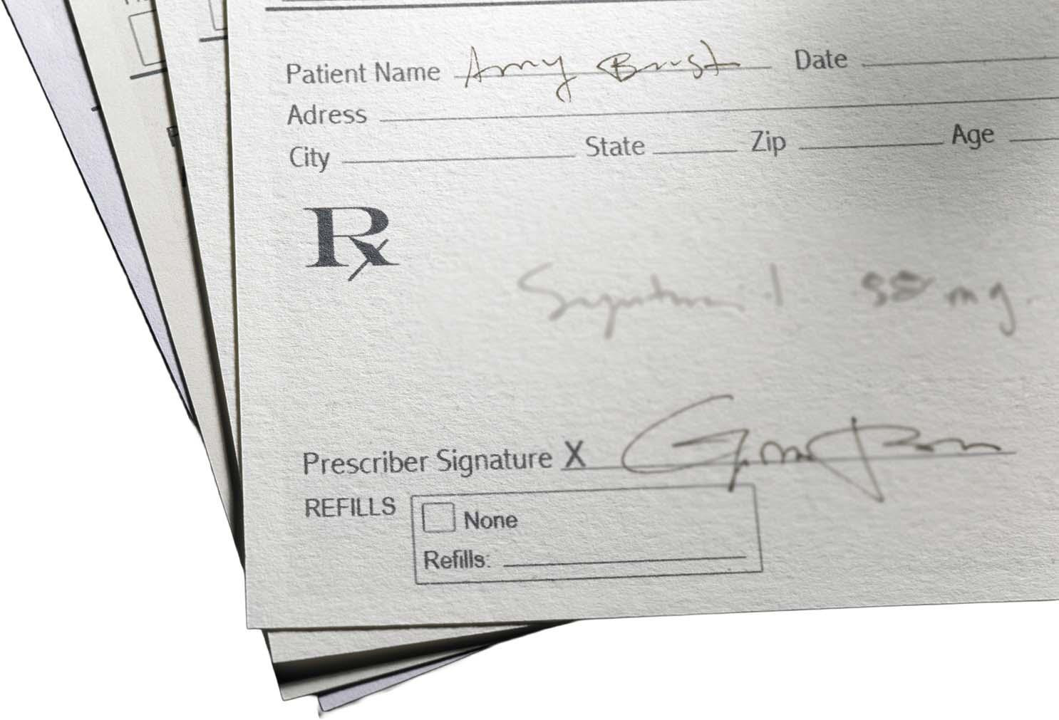 A prescription written on the top sheet a prescription pad.