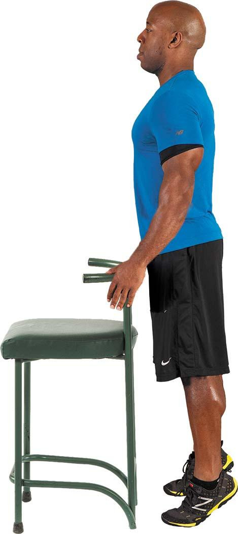 A man performs the heel raise exercise as described in the article.