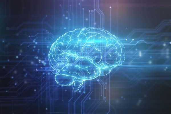 Photo-illustration of a human brain glowing blue against a dark blue background.