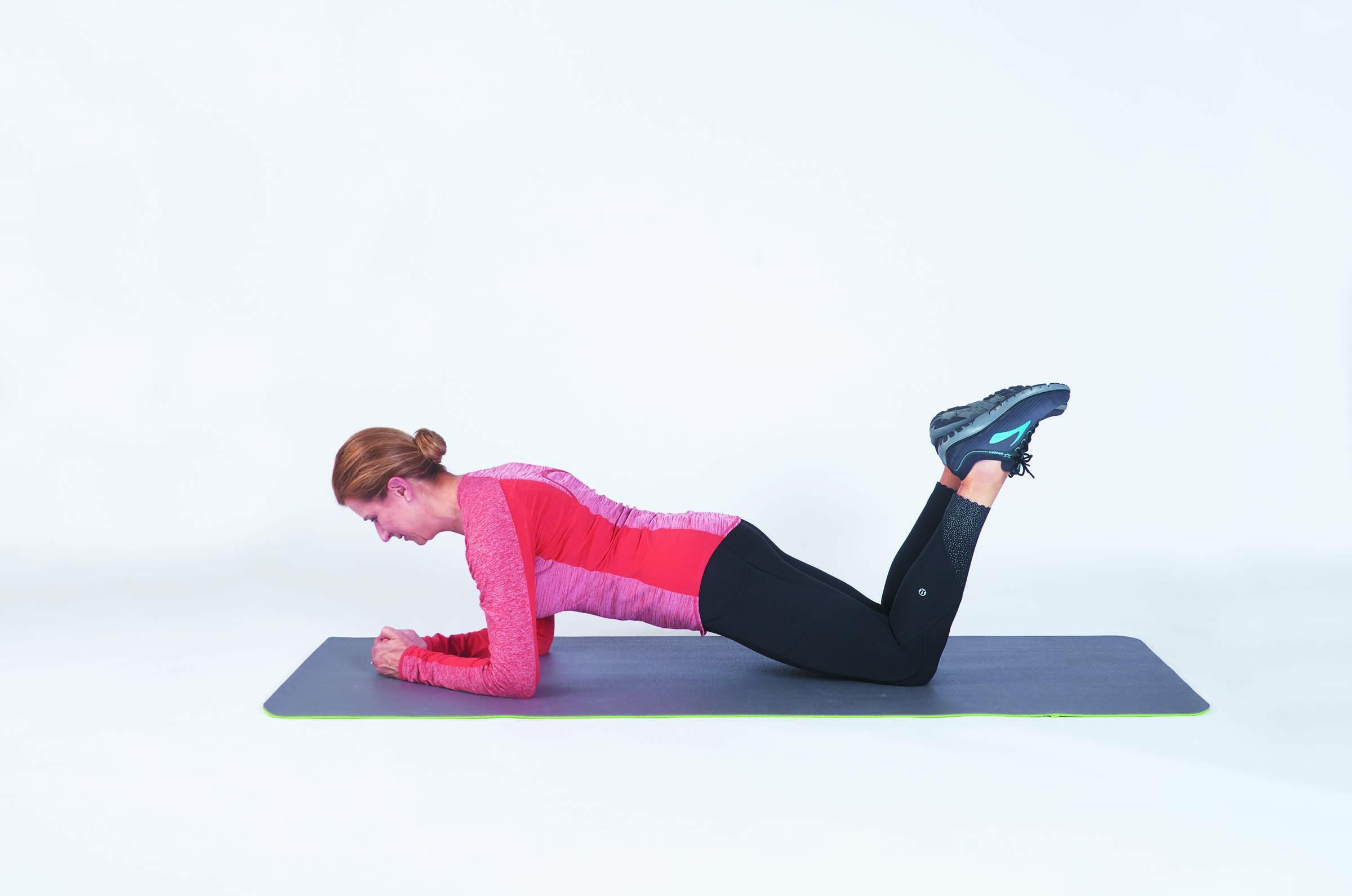A woman performs the kneeling plank exercise as described in the article.