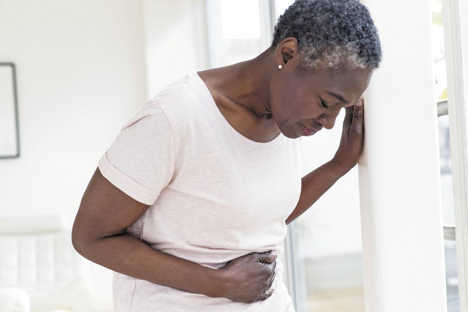 Woman With Bowl Problems Holds Her Stomach