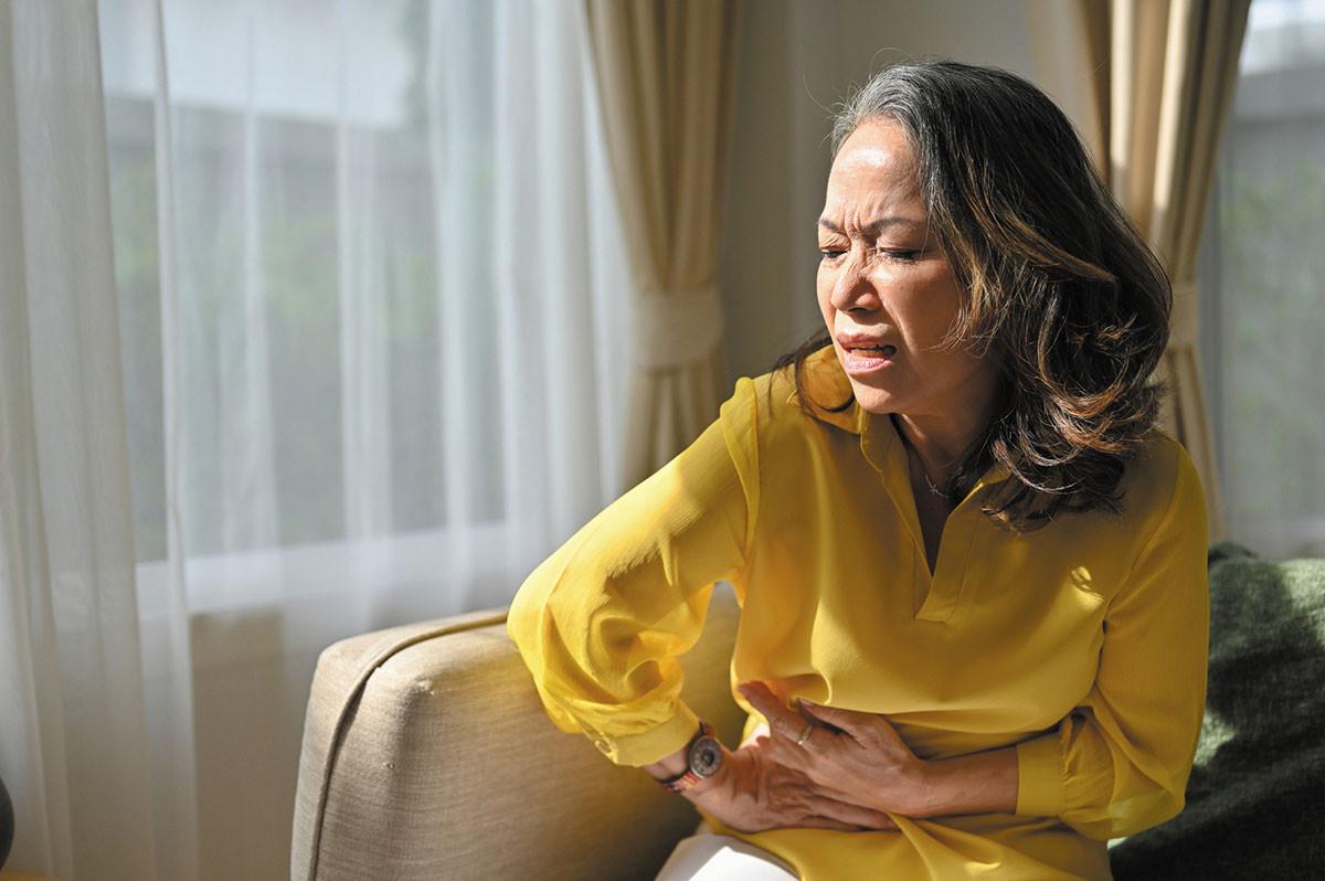 woman hunching over in discomfort