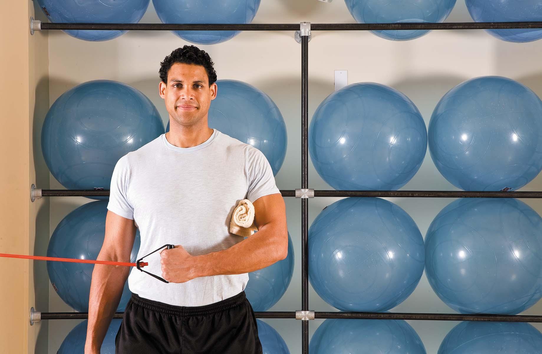 A man shows the starting position for the external rotation exercise as described in the article.