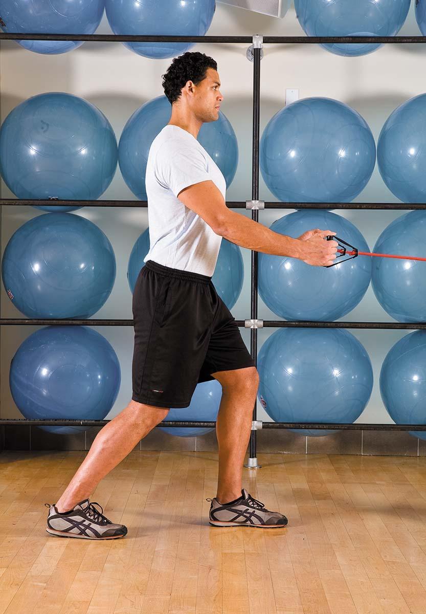 A man shows the starting position for the standing row exercise as described in the article.