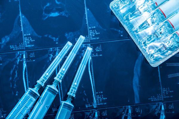 Photo illustration with fresh syringes on a background of MRI scans, with a blue tint applied to everything.