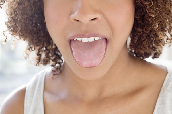 Close-up of a woman sticking out her tongue.
