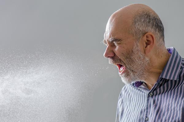 How does a cold virus spread from person to person?