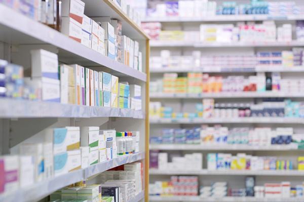 Shelves in a pharmacy stocked with various products; the shelves in the background are out of focus.