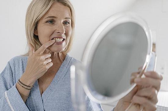 How menopause can affect oral health, including tooth decay, dry mouth, and shifting teeth featured image