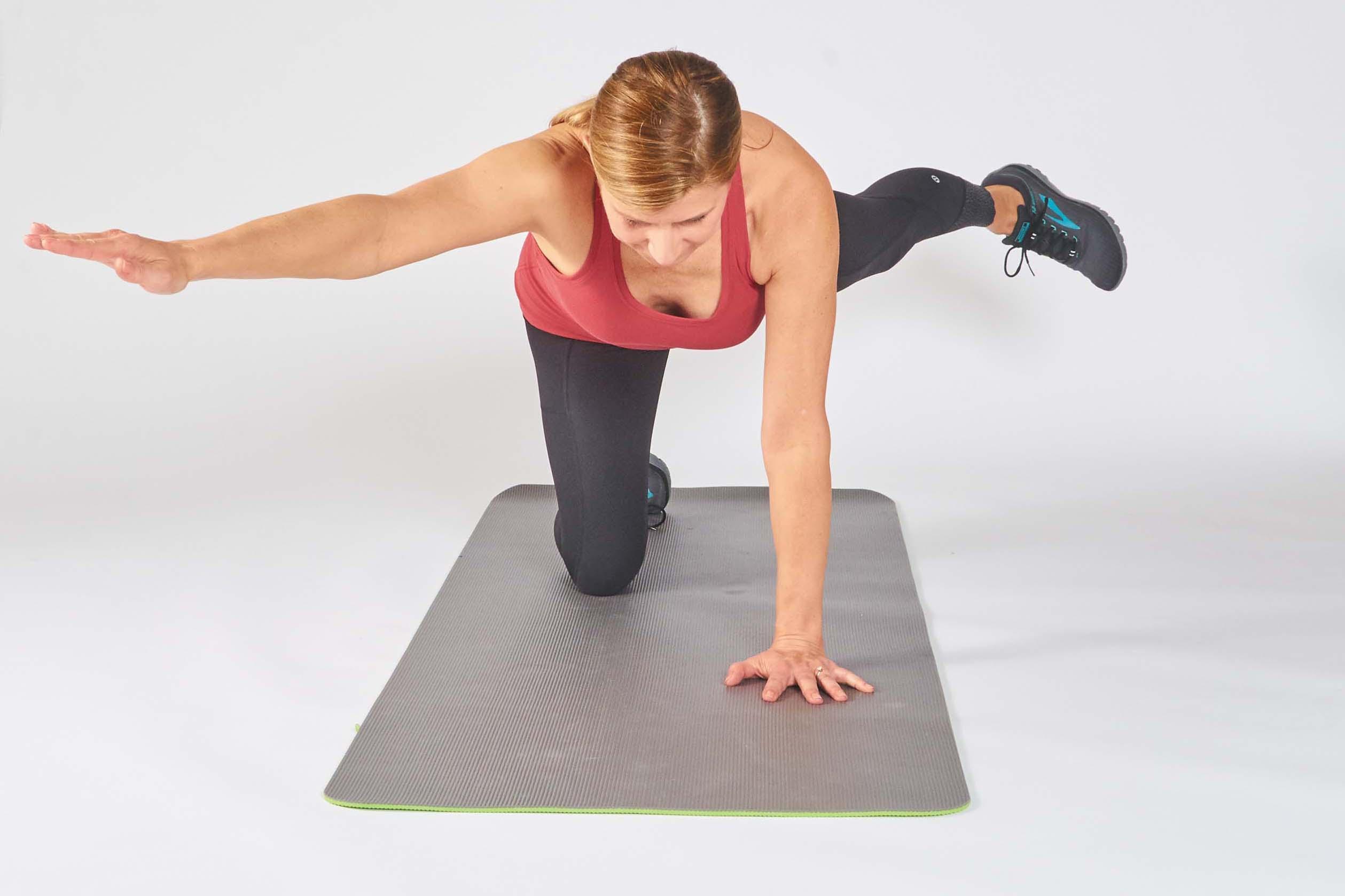 A woman demonstrates how to make the bird dog exercise harder, as described in the article.