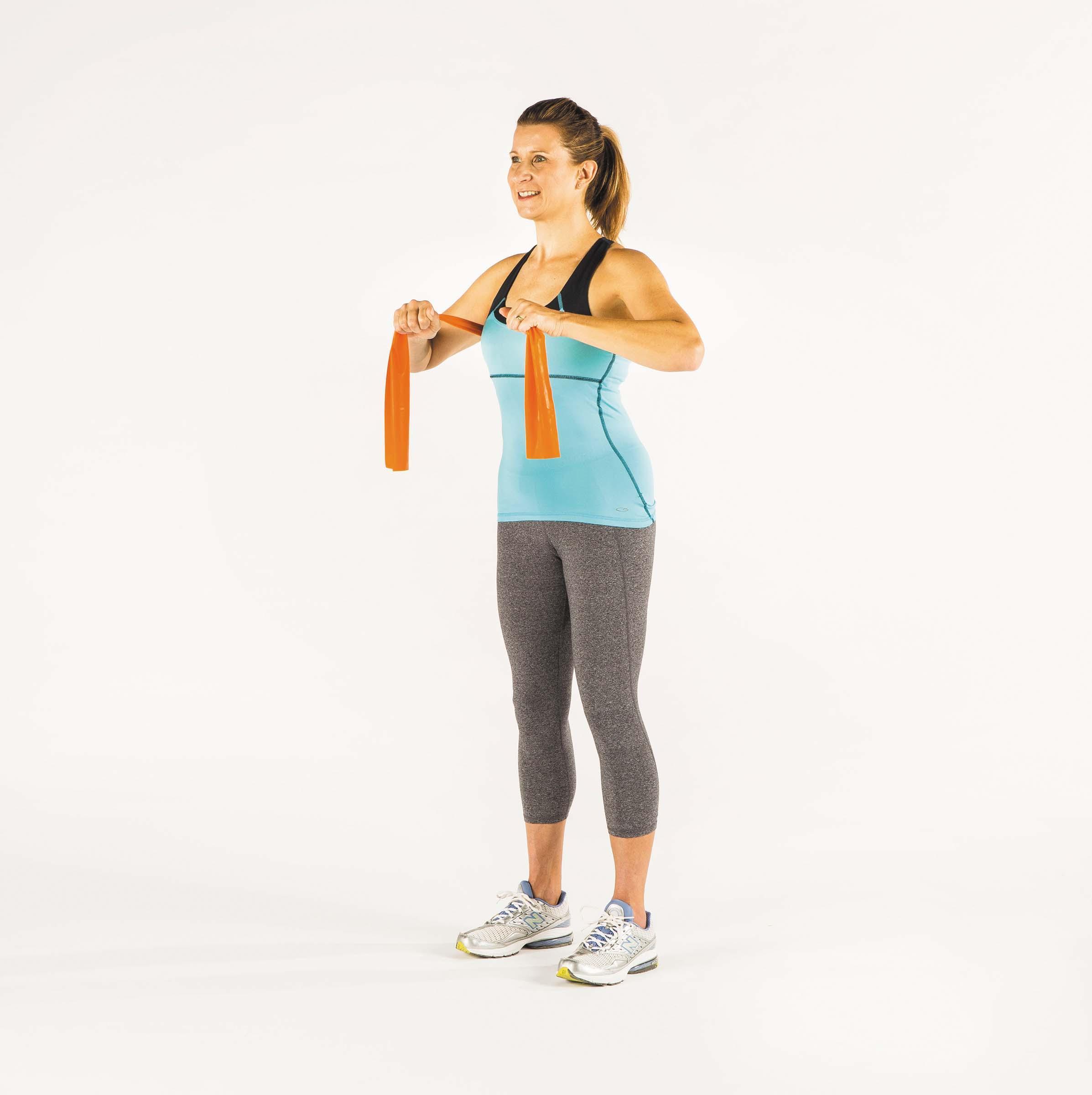 A woman shows the starting position for the chest press exercise as described in the article.