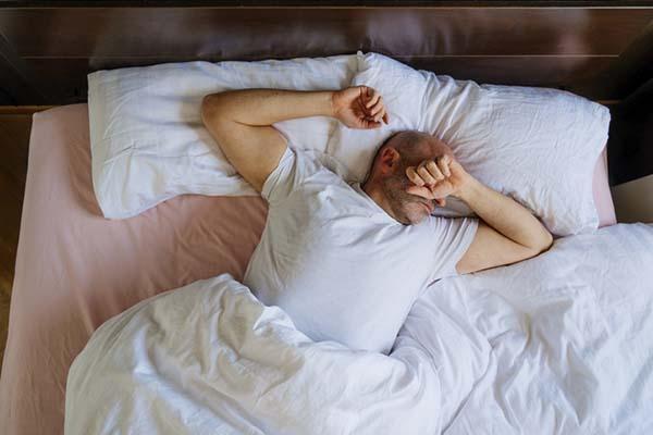 Why can exhaustion persist after cancer treatment?