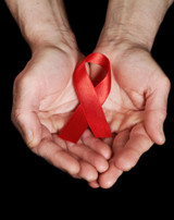 Hands-holding-AIDS-ribbon