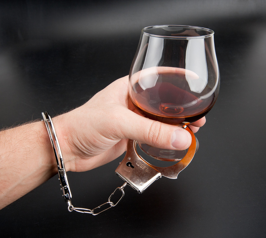 bigstock-A-Hand-Locked-To-Glass-Of-Alco-13387529