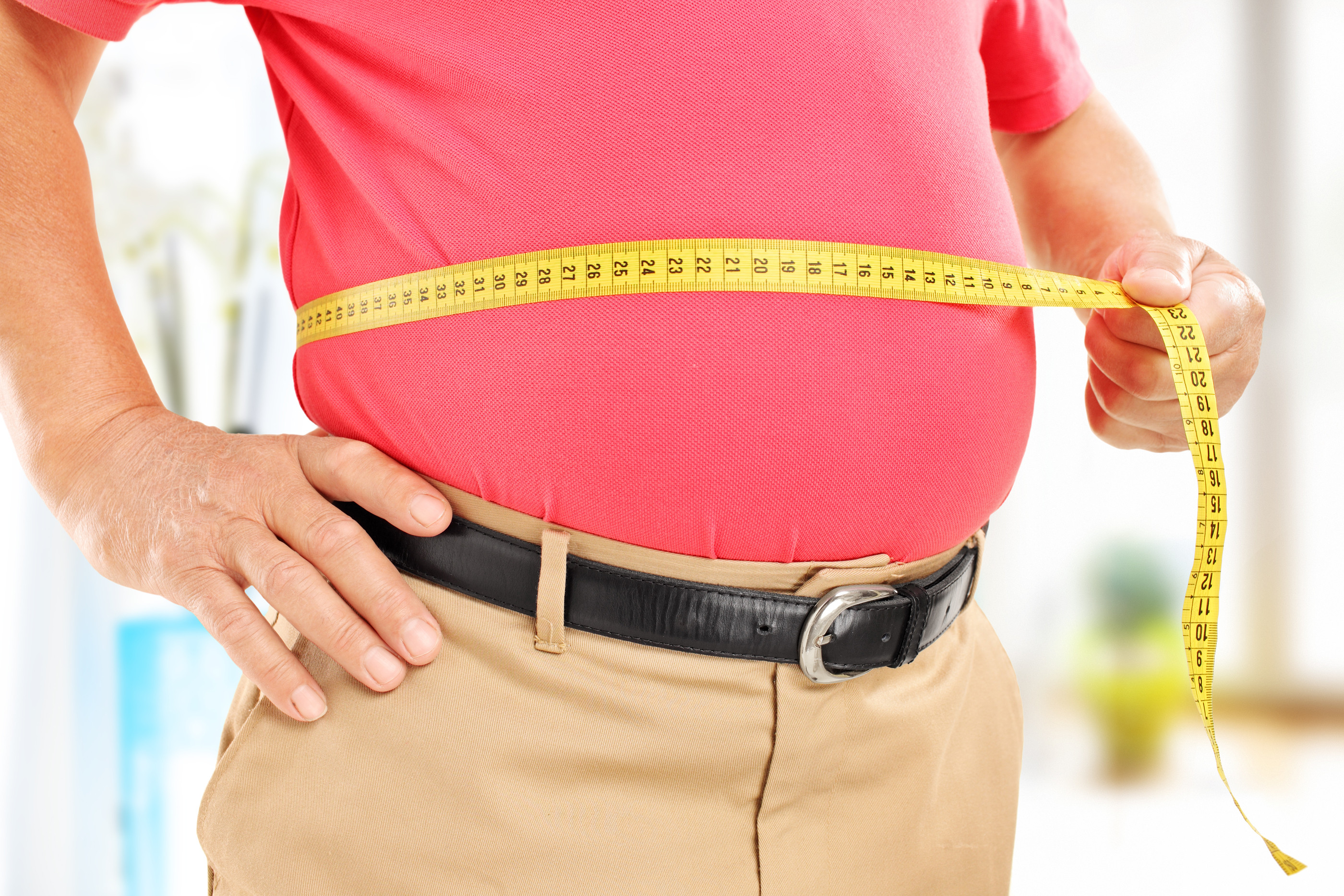 bigstock-man-waist-fat-measuring-hi-82472636